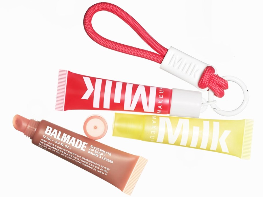 three Milk Makeup lip balms and a keychain