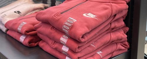 A stack of folded Nike hoodies