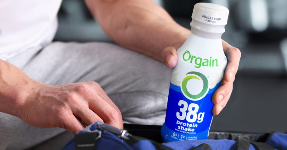 man packing a Orgain 38g High Protein Shake into a gym bag