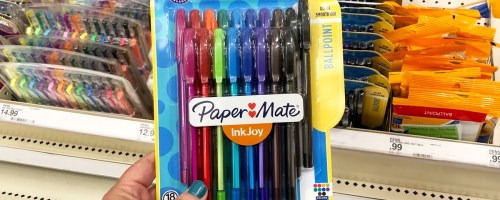 hand holding up a colorful set of Paper Mate InkJoy Pens in store