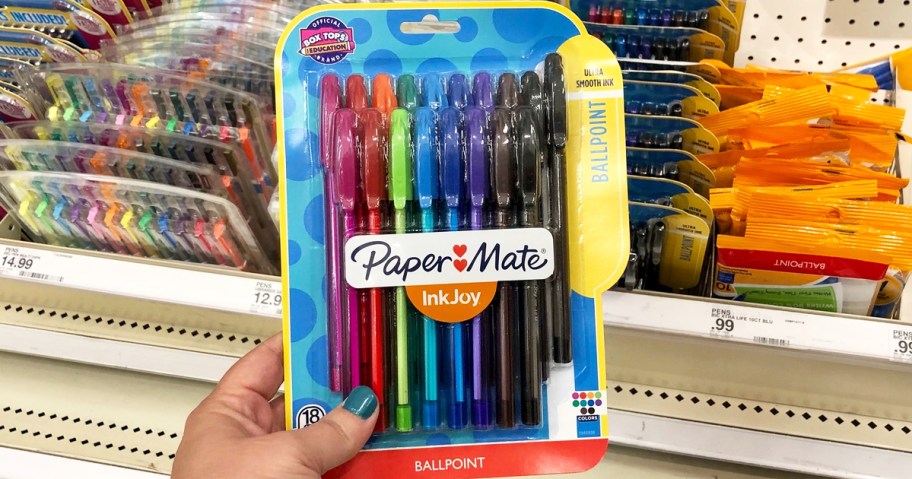 hand holding up a colorful set of Paper Mate InkJoy Pens in store