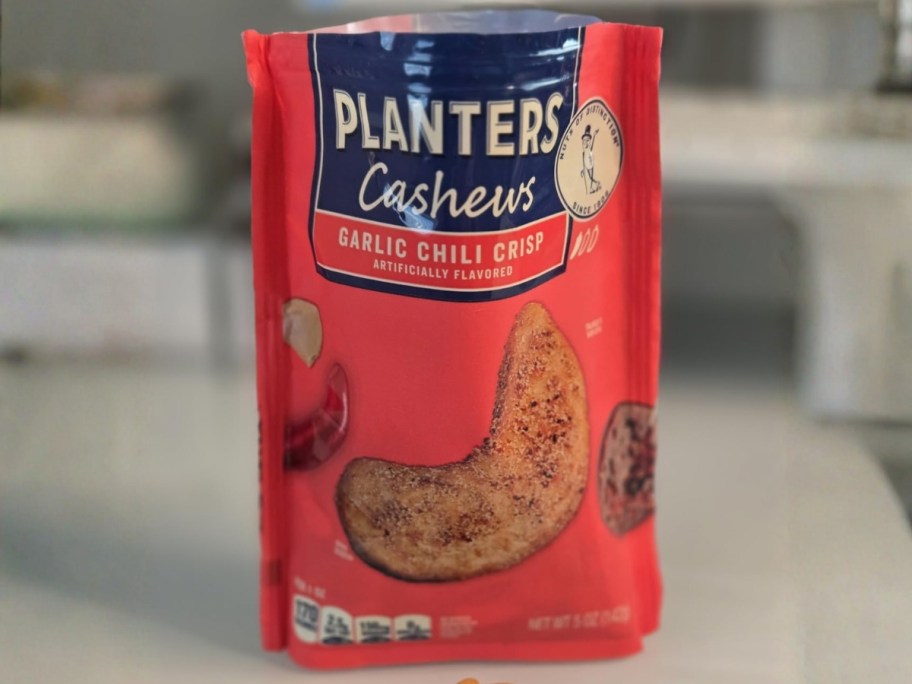 bag of planters garlic chili crisp cashews sitting on kitchen counter
