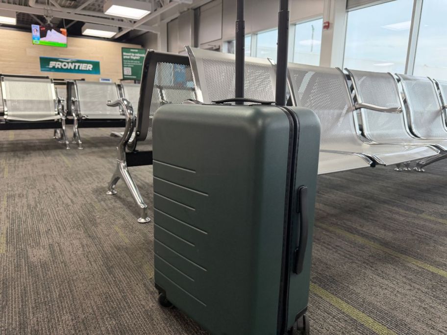Quince Large Check-In Suitcase in airport