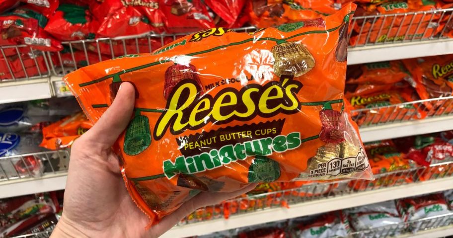 Hand holding a bag of Reese's miniatures