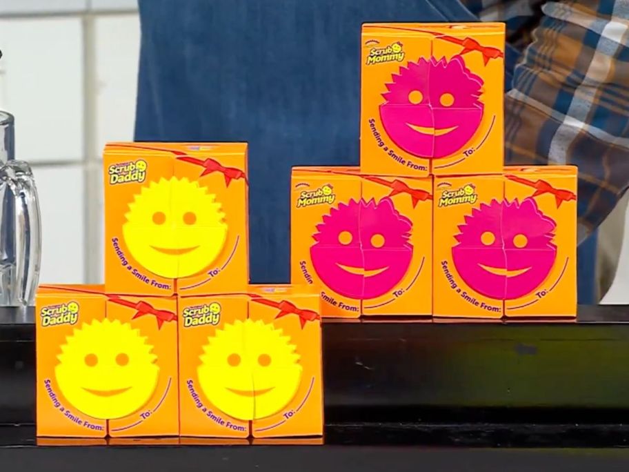 Six Scrub Daddy and Scrub Mommy Sponges in gift boxes