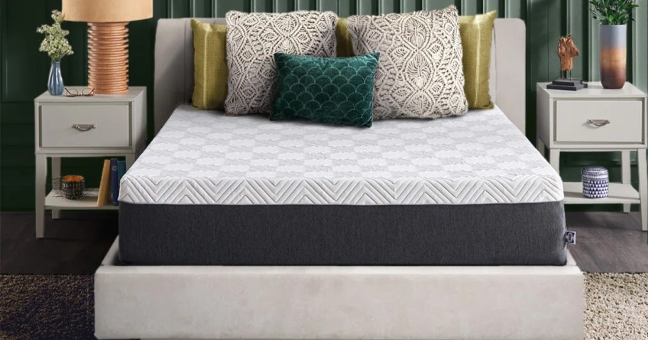 sealy medium hybrid mattress on gray bed fram in bedroom