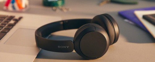 black pair of Sony WH-CH520 Wireless Headphones on desk