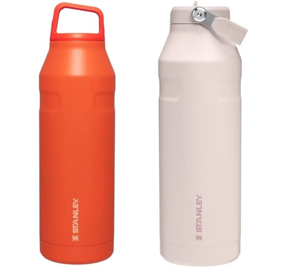 orange and light pink stanley tumblers on white background