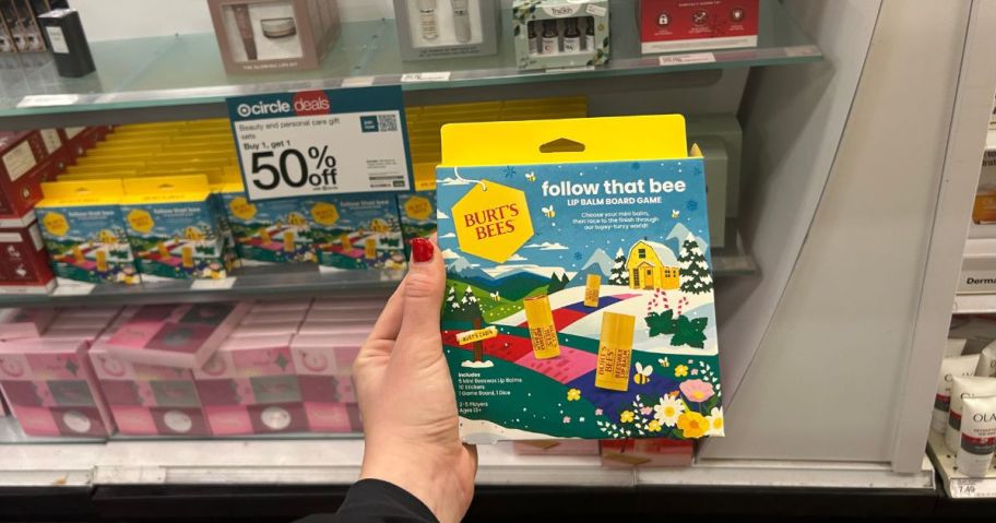 A person holding a Burt's Bees gift set in a store