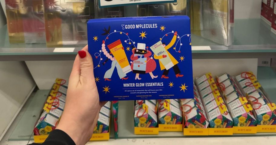 A person holding a beauty gift set in a store