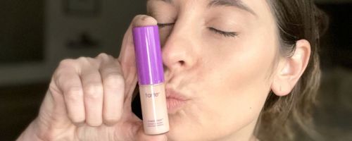 woman kissing a Tarte shape tape concealer mini