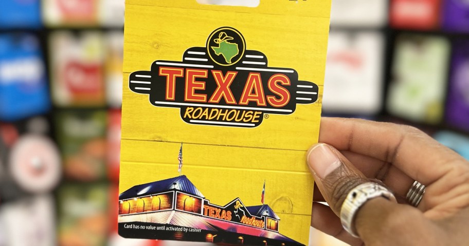 hand holding up a yellow Texas Roadhouse gift card
