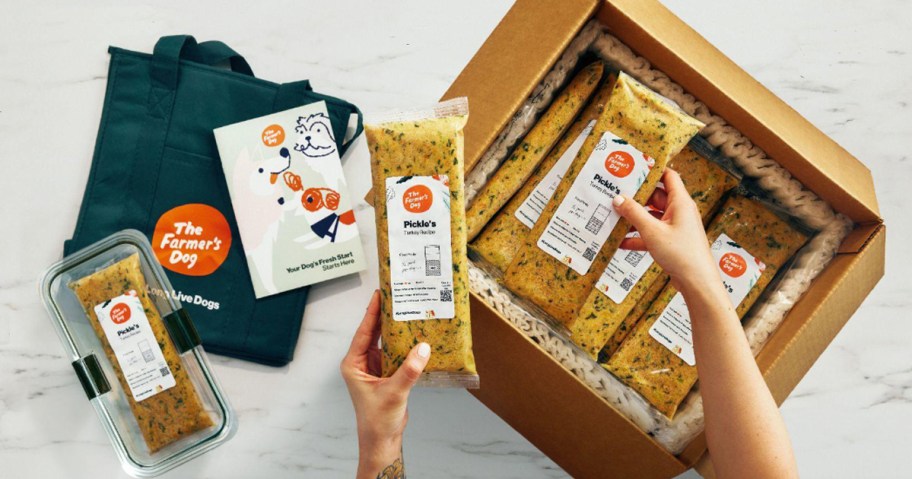 person taking packs of farmers dog food out of box