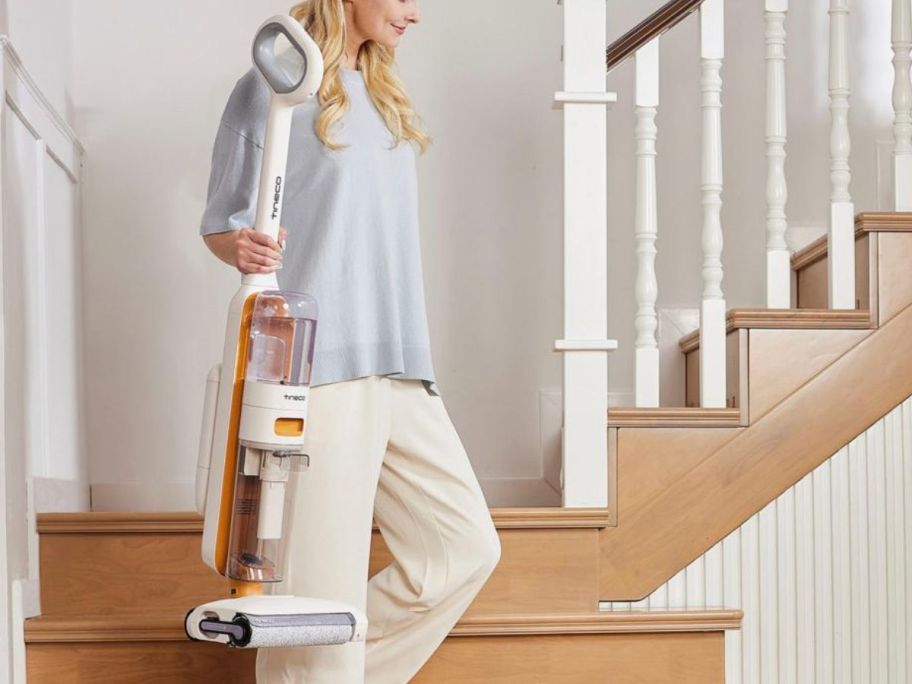 woman holding Tineco GO H2O Max Complete Cordless Floor Washer Vacuum