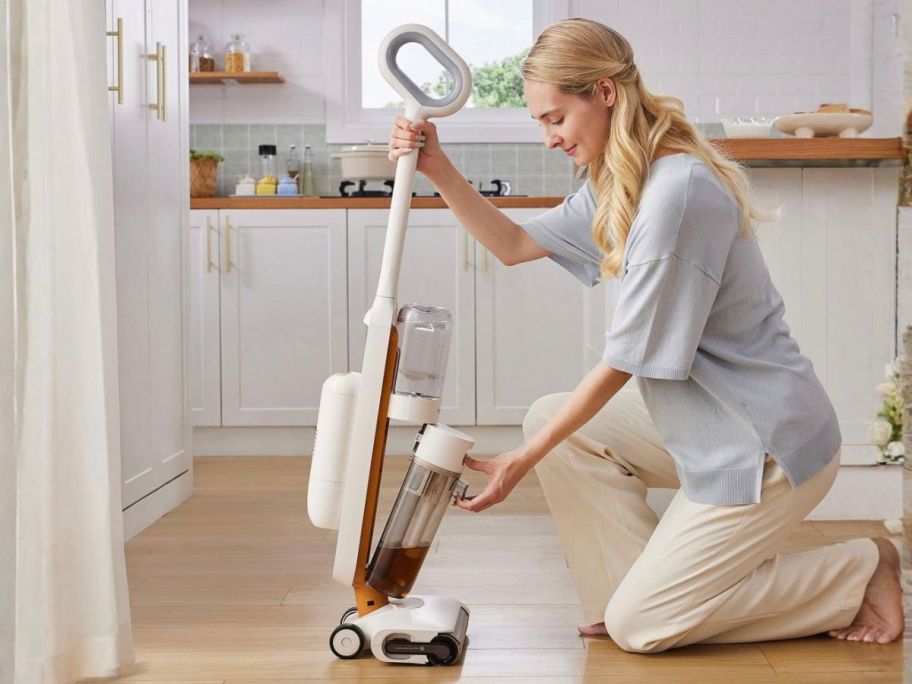 woman emptying Tineco GO H2O Max Complete Cordless Floor Washer Vacuum