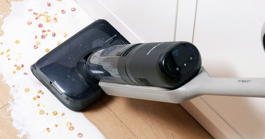 using vacuum mop to clean up spilled milk and cereal on floor