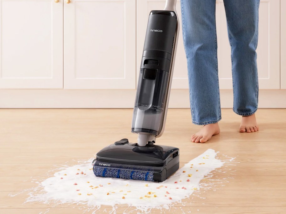 using vacuum mop to clean up spilled milk and cereal on floor