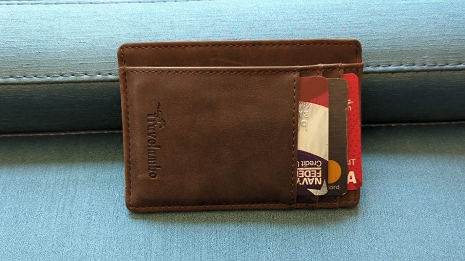 a brown slim wallet with cards in the front slots