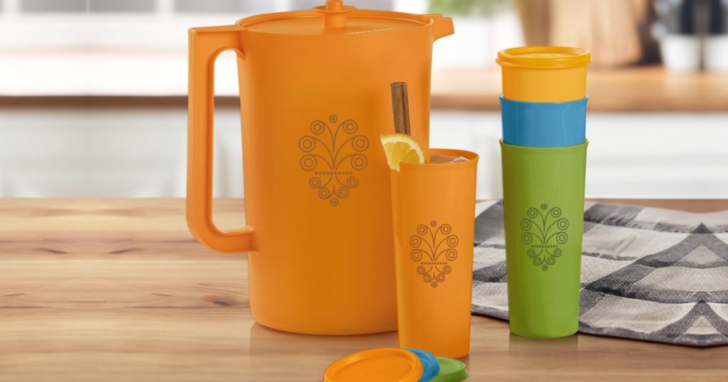 Retro styled, Tupperware pitcher and four tumblers on wooden countertop in kitchen