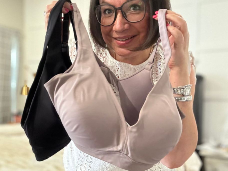Woman holding two Vanity Fair Beauty Back Bras