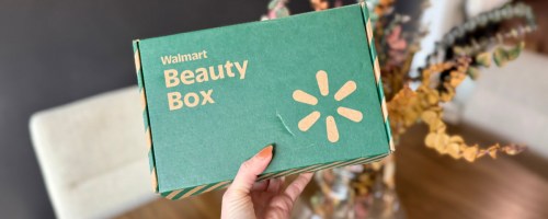Woman holding up green Walmart beauty box
