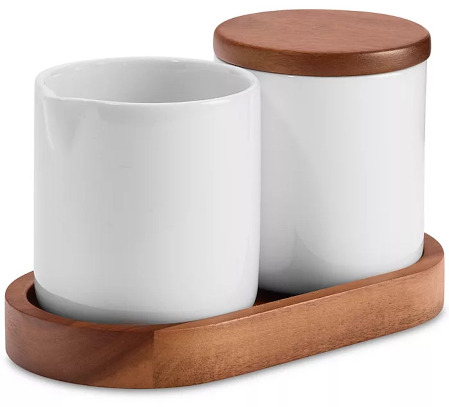 white dishes with wood lids in wood tray