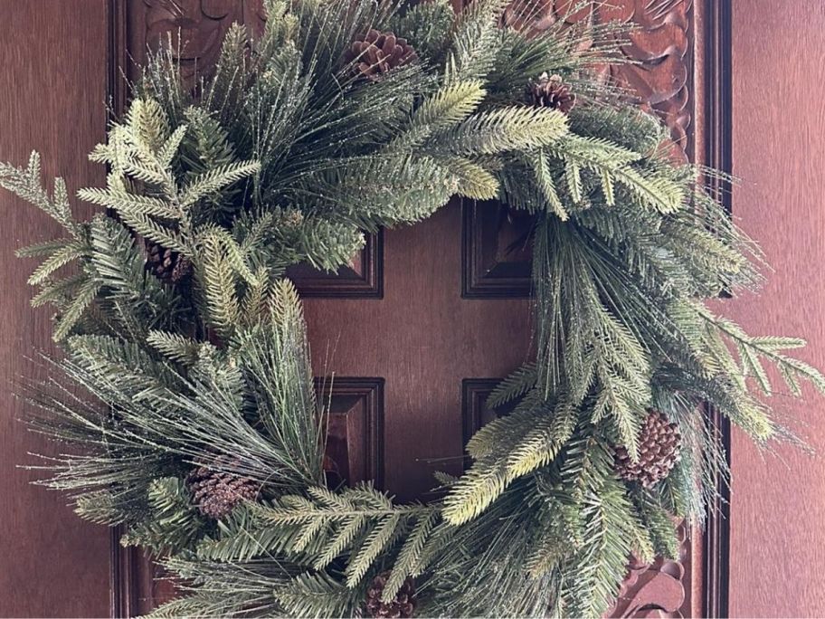 Wreath with pinecone hung on the door
