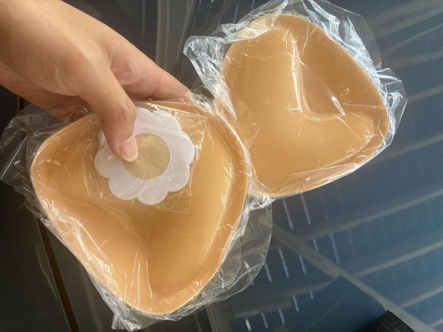 hand holding adhesive bra inserts