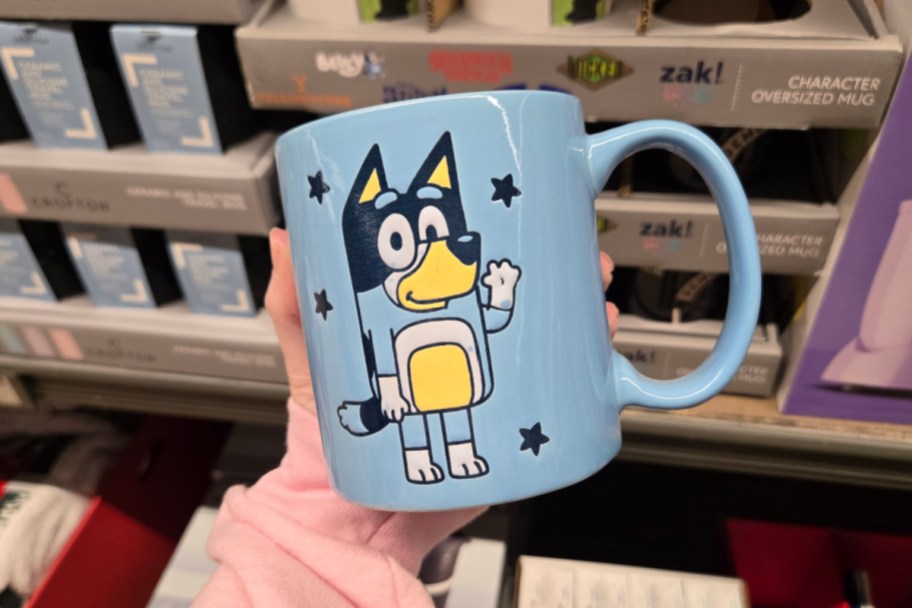 hand holding blue bluey mug