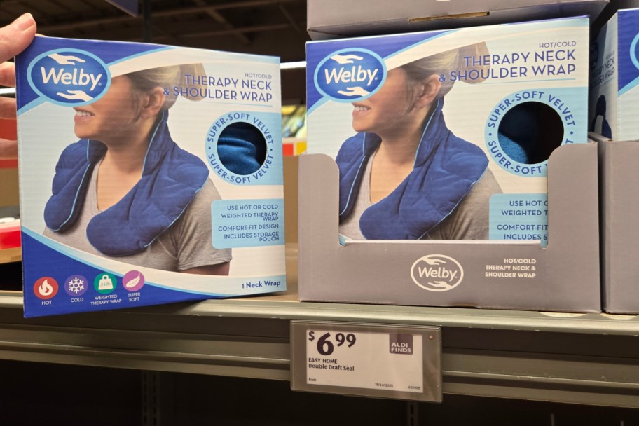 hand grabbing neck wrap off shelf