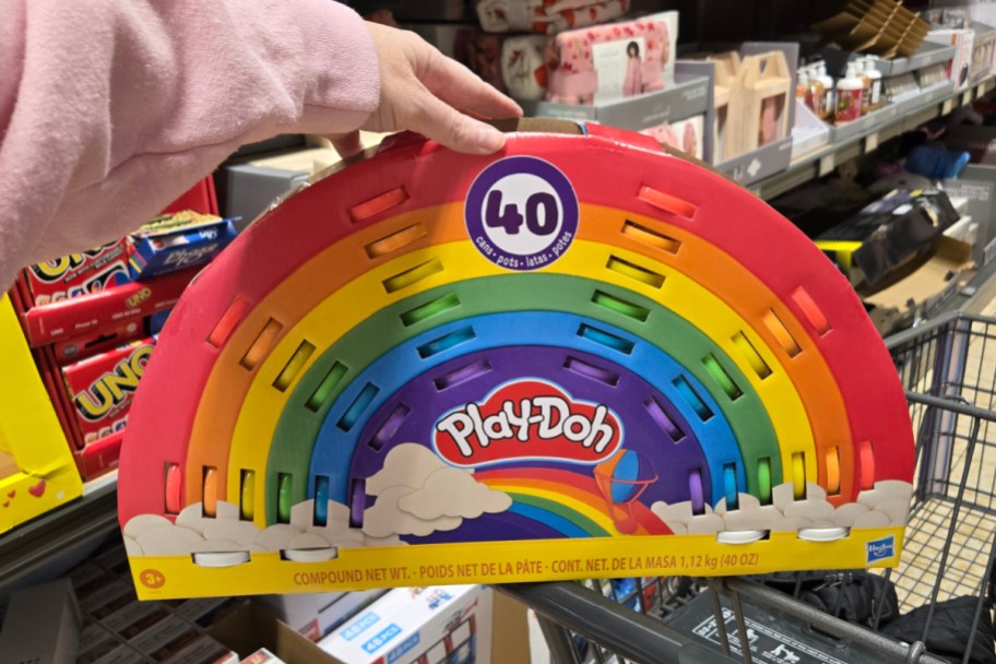 hand holding tainbow play doh in store