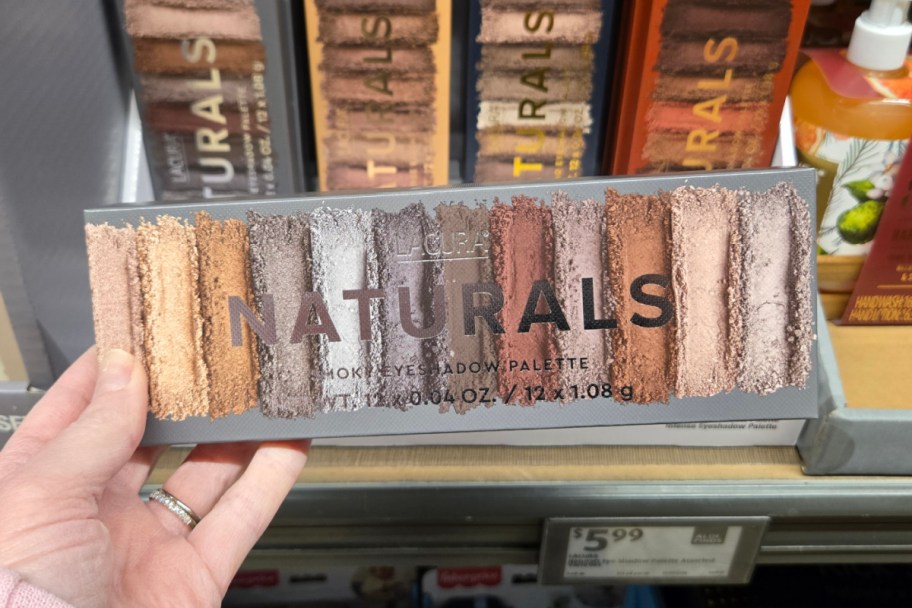 hand holding eyeshadow palette in store