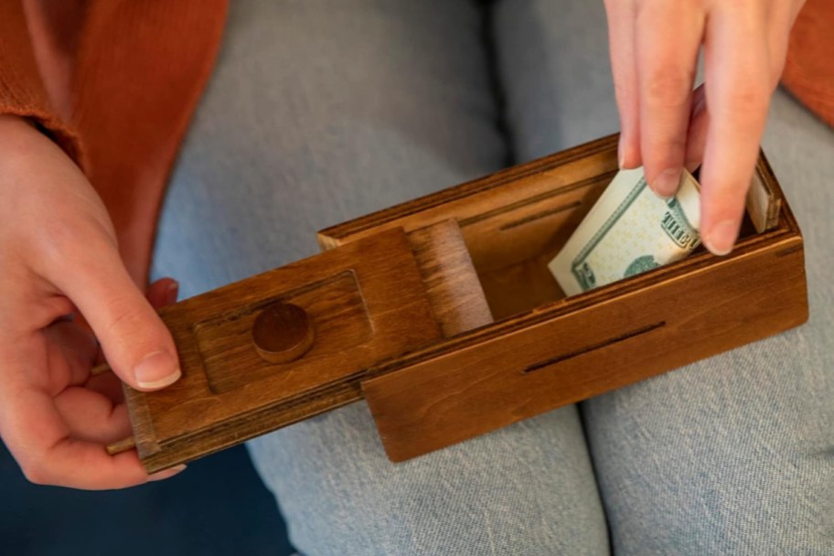 taking money out of wooden box