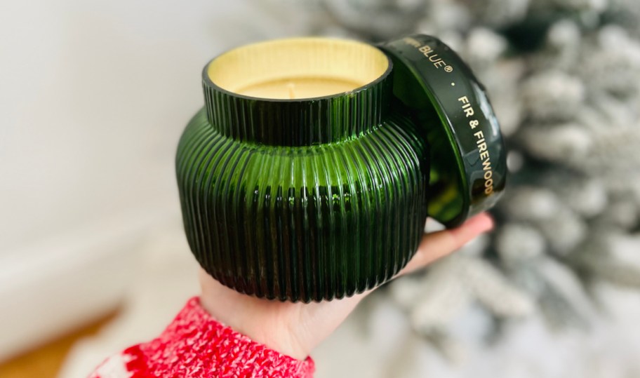 hand holding green candle