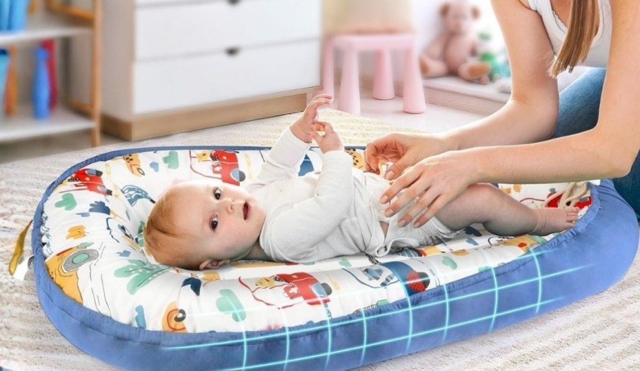 mom and baby in a baby lounger