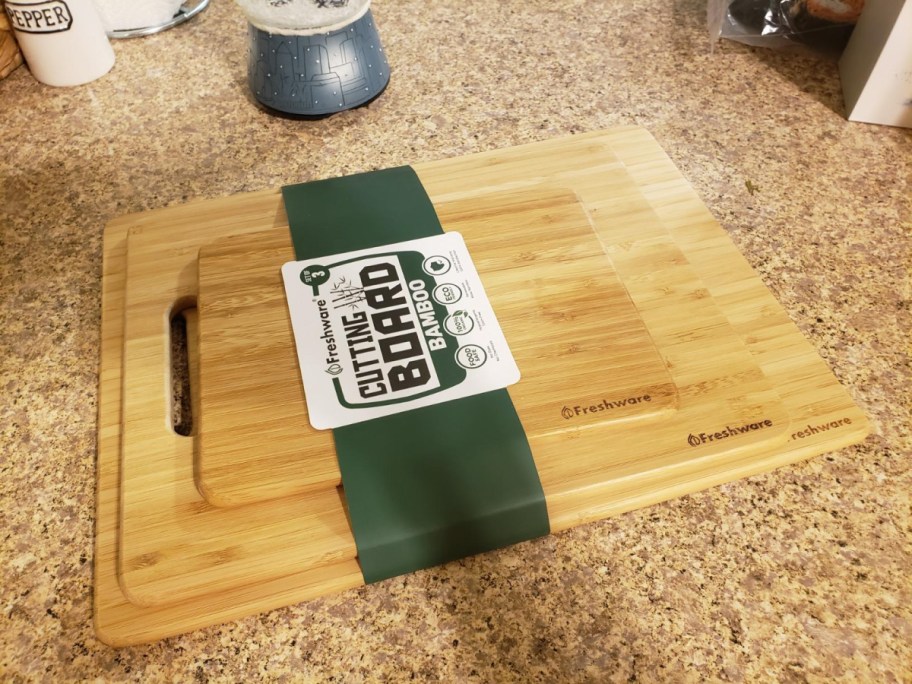 Three bamboo cutting boards stacked.