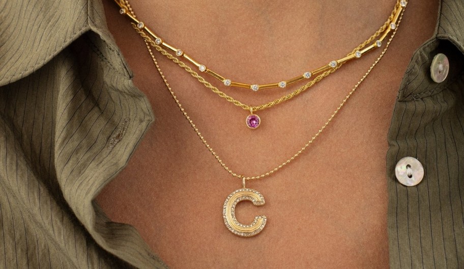 woman wearing stacking necklaces including 2 initial styles 