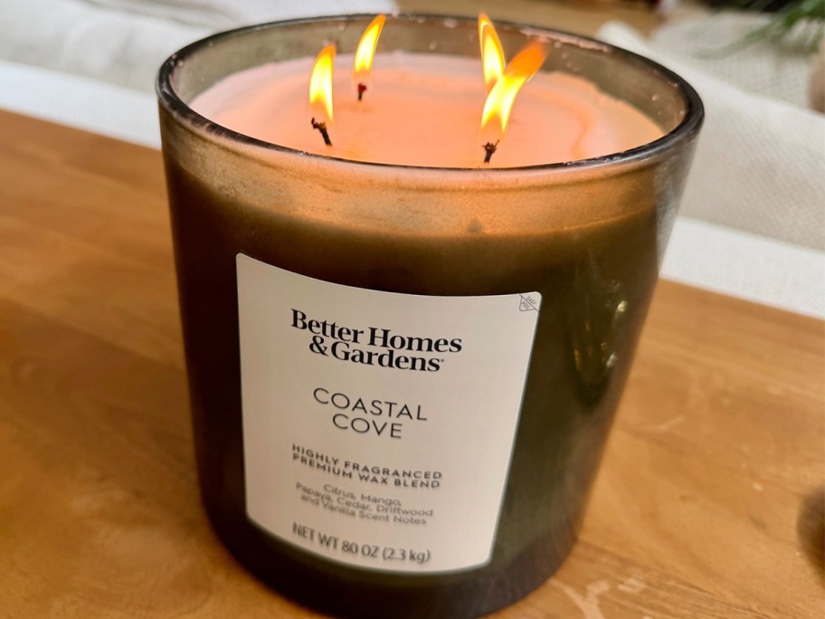 large green 4 wick candle on table