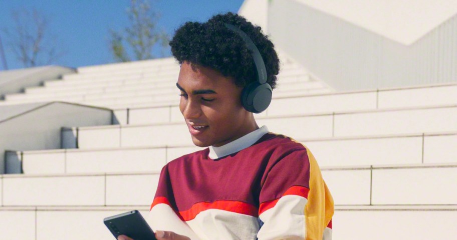 teen wearing black sony headphones