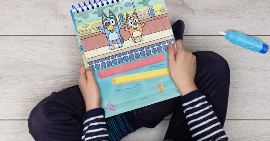 child playing with a bluey aqua pad