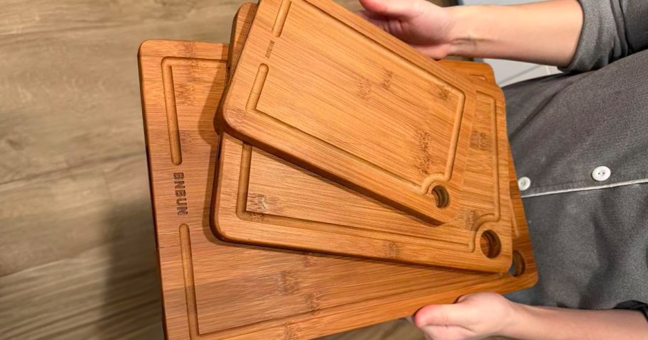 person holding cutting board set