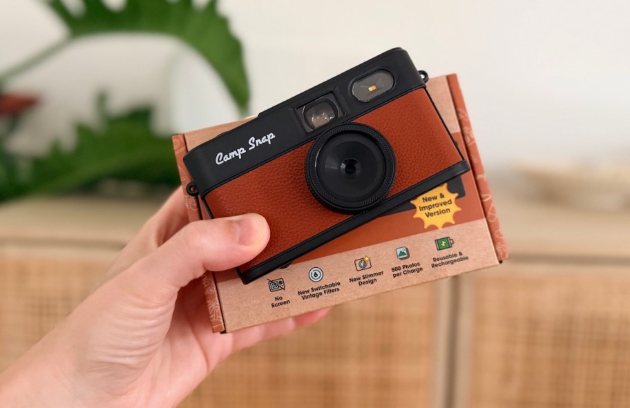hand holding camp snap camera with box