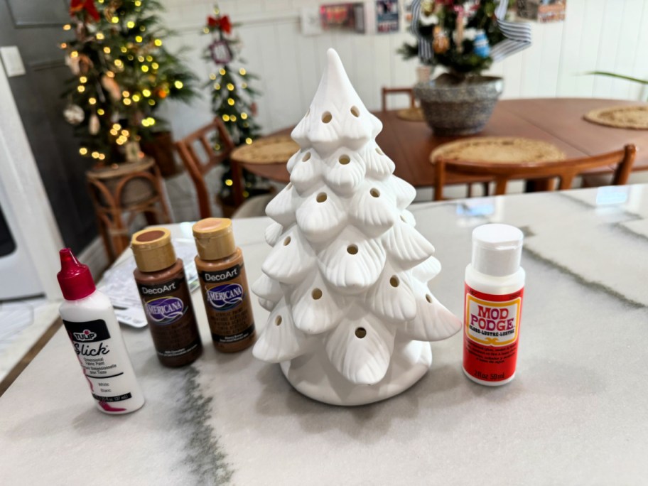 ceramic christmas tree with paint on the counter (