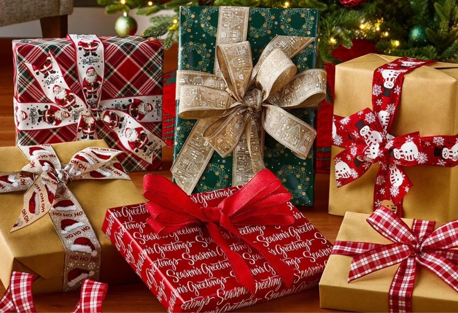 Wrapped gifts and holiday-themed wire ribbons under the tree