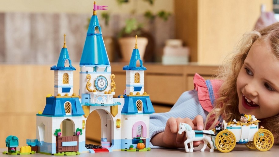 little girl playing with the LEGO Disney Cinderella Castle Building Kit