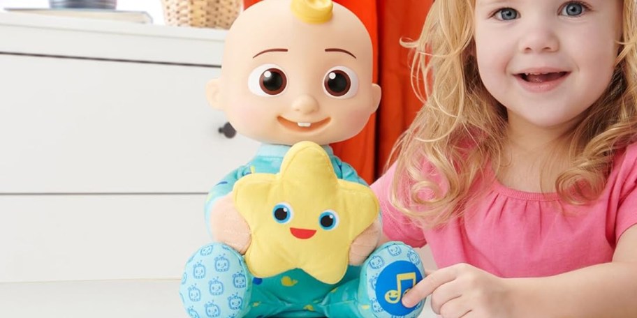 girl playing with cocomelon doll 