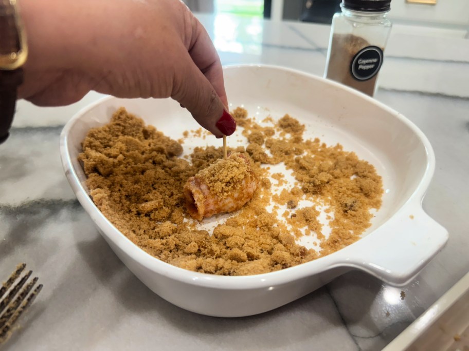 dipping sausages into brown sugar