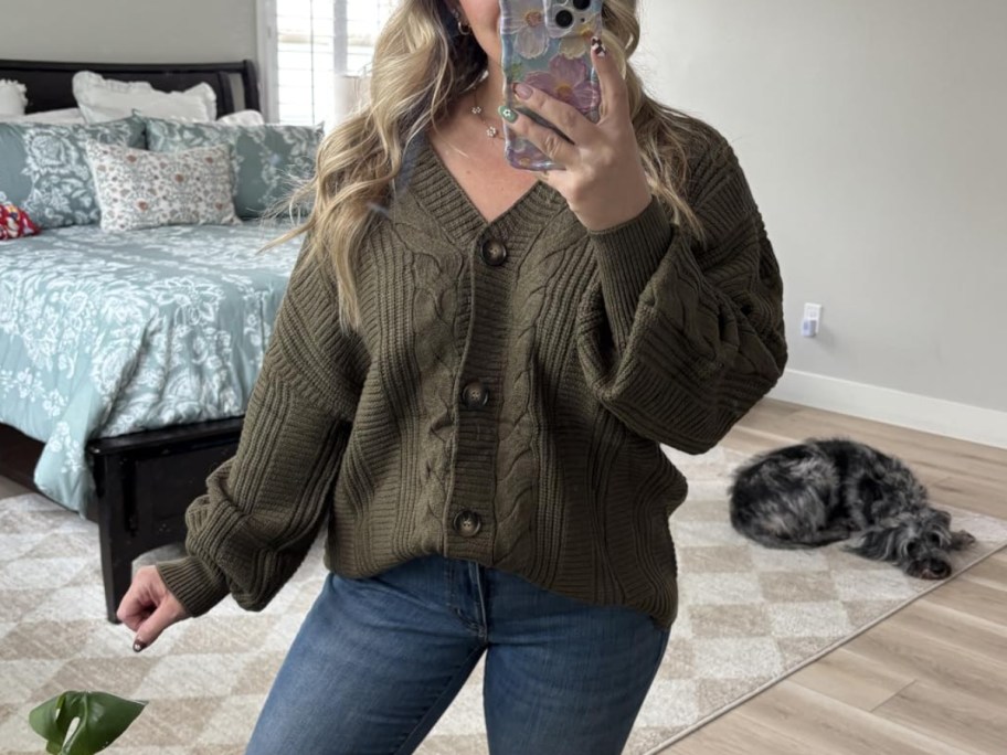 woman in green cardigan taking selfie