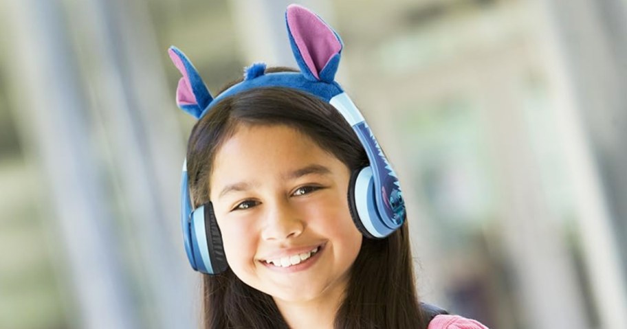 girl wearing a pair of blue headphones with stitch ears on top