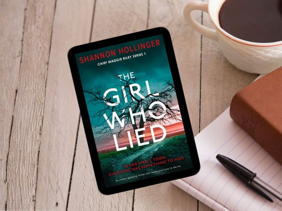 The Girl Who Lied by Shannon Hollinger on kindle on desk